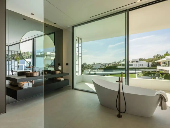 Primary bathroom in Villa 12 featuring marble finishes and bespoke cabinetry.