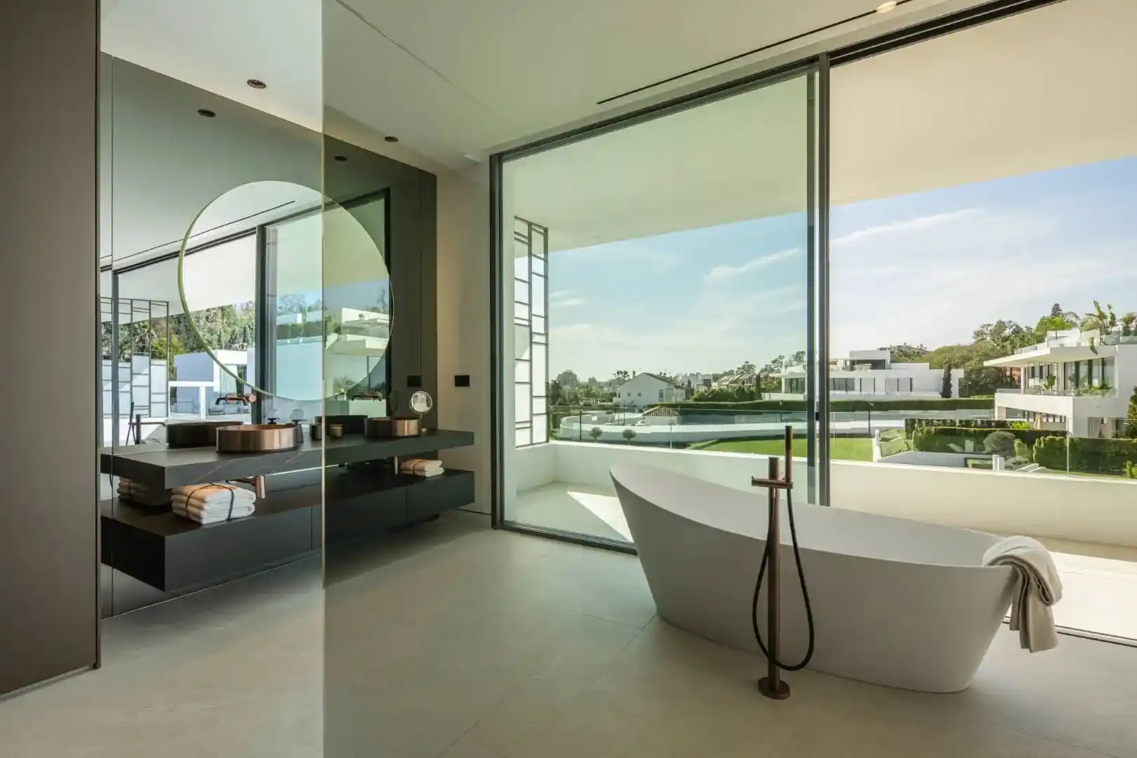 Primary bathroom in Villa 12 featuring marble finishes and bespoke cabinetry.