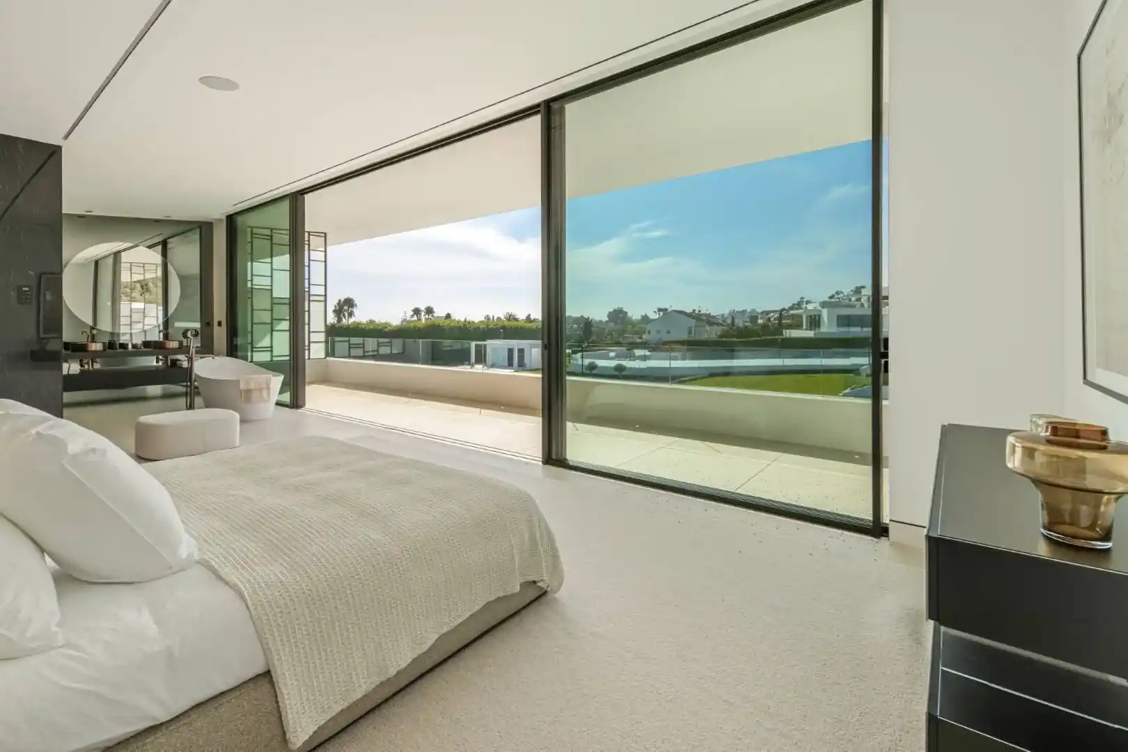 Primary bathroom in Villa 12 featuring marble finishes and bespoke cabinetry.