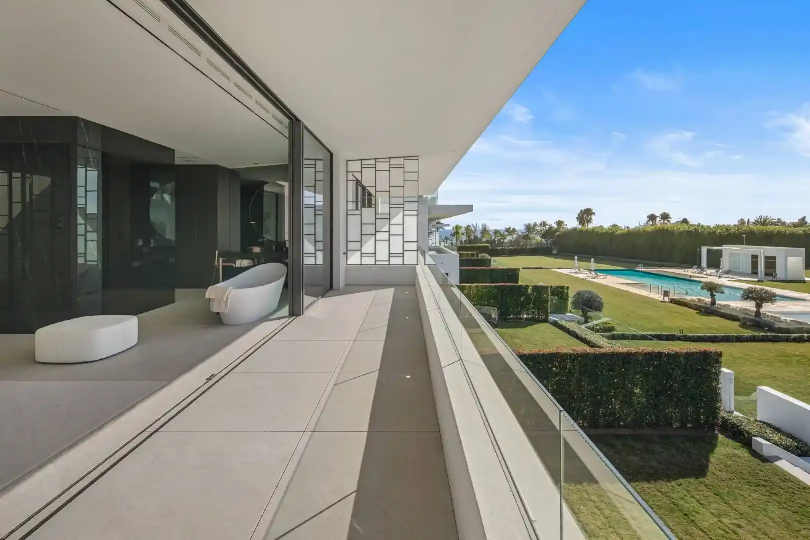 Primary bathroom in Villa 12 featuring marble finishes and bespoke cabinetry.